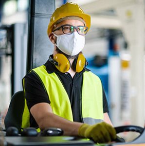 Worker wearing safety vest, hard hat, and protective apparel