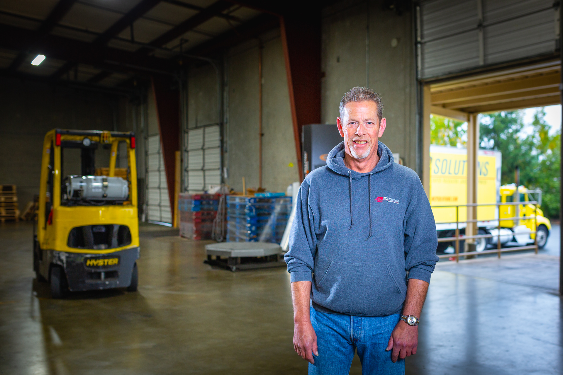 Jim Daeley standing on the WCP Solutions Burlington, Washington loading dock where paper and packaging is loaded on to trucks for delivery to customers.