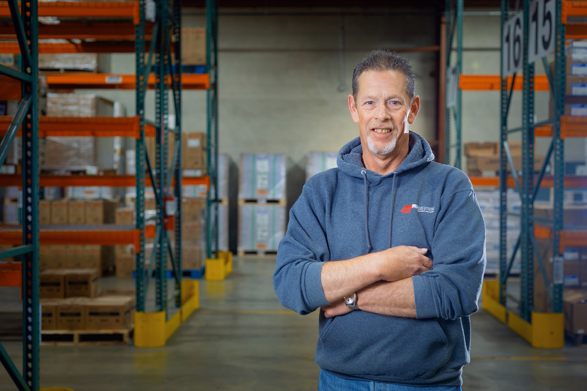 Jim Daeley, the WCP Burlington, WA operations manager standing in the warehouse with packaging, paper, and janitorial supplies around him