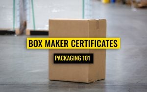 Corrugated box in a concrete warehouse floor with text in front that says "Box Maker Certificates, packaging 101"