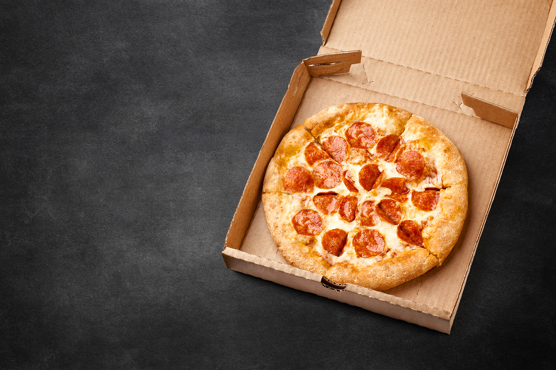 Pepperoni pizza in a corrugated pizza box