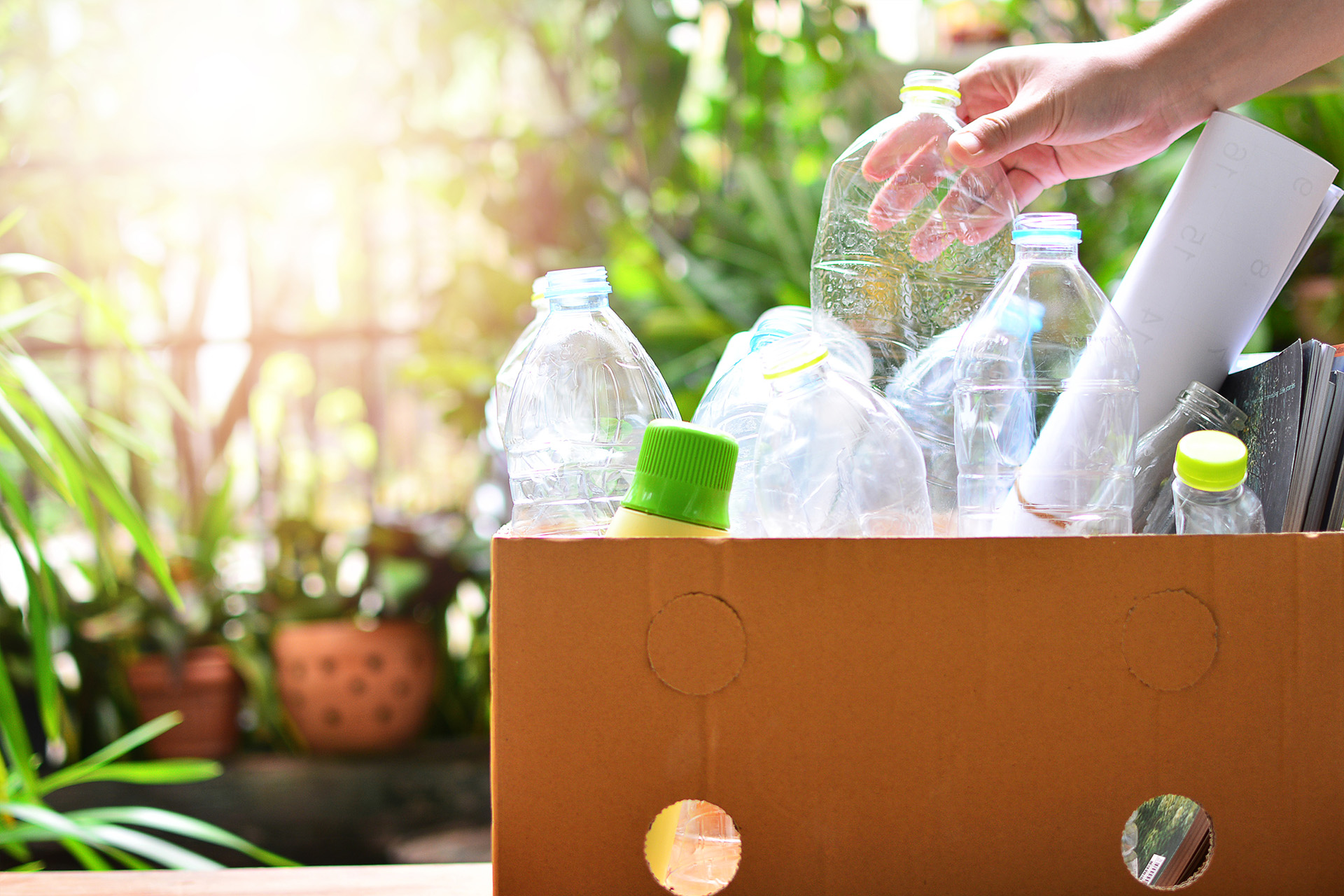 Box full of plastic bottles and items for recycling