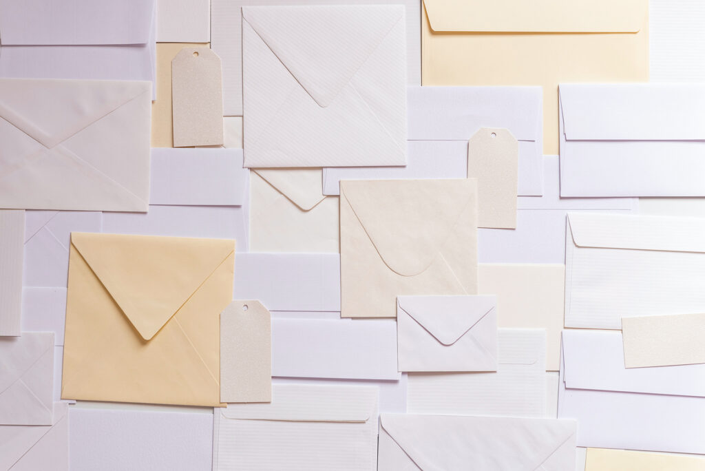 Different types of envelopes laid out flat on a table