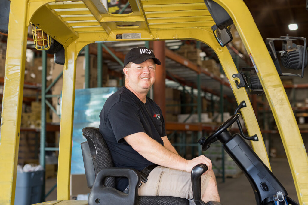 Chris driving a forklift