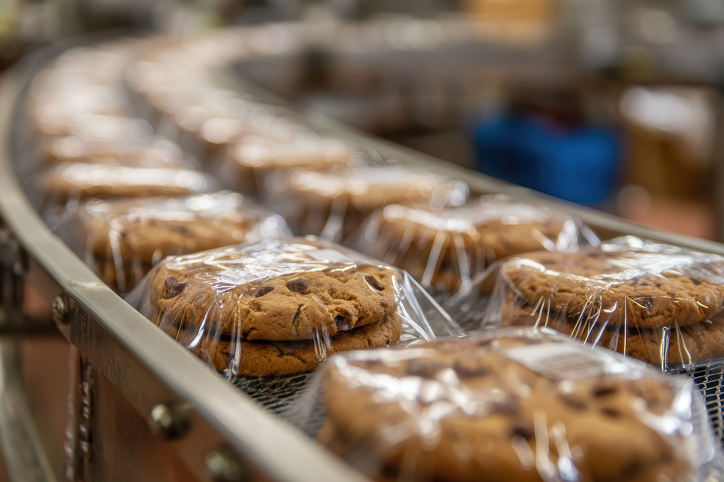 Cookies being wrapped in packaging on assembly line