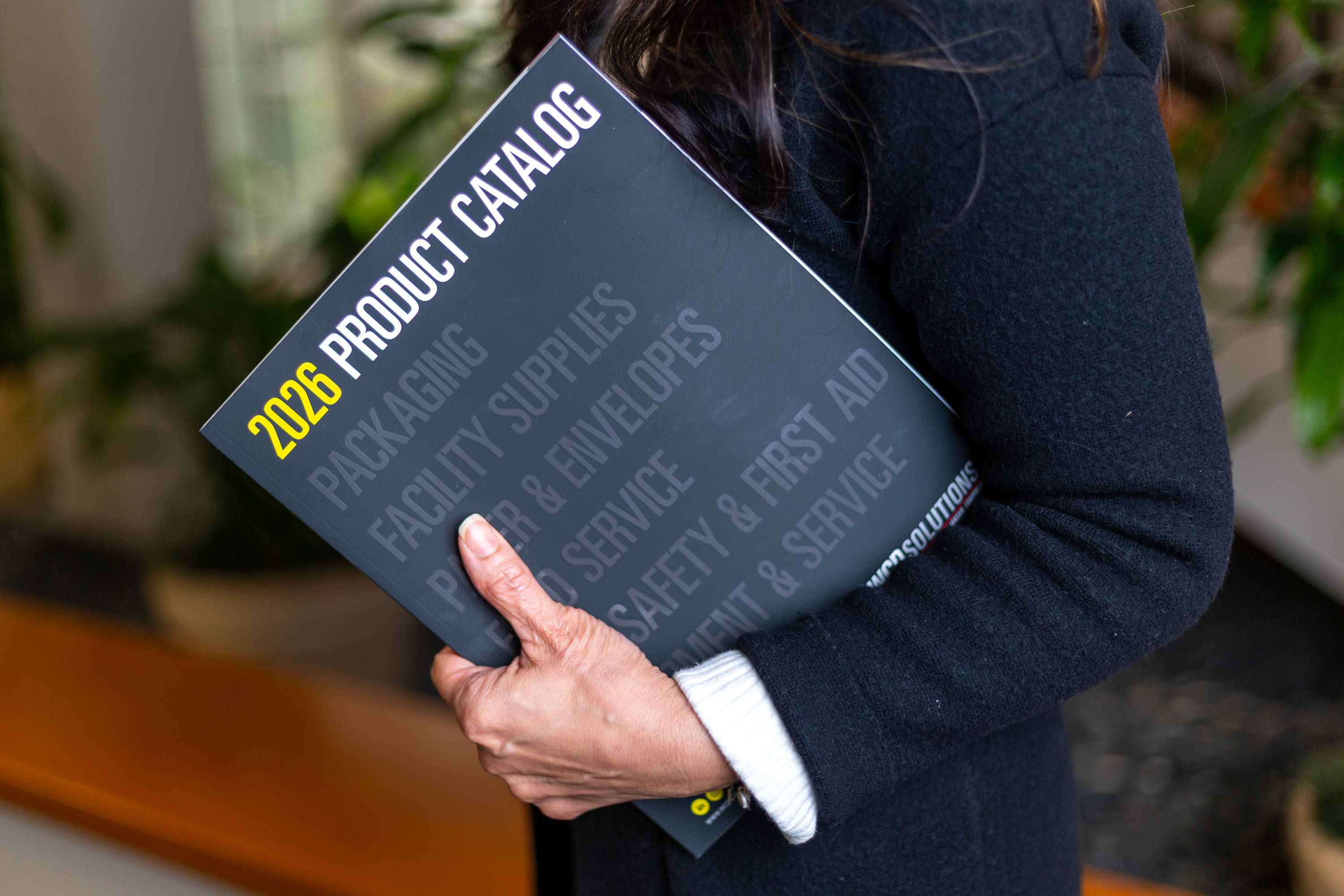 Woman holding 2026 Product Catalog